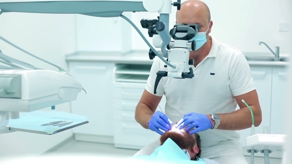 Professional Dentist Examining The Patient alt