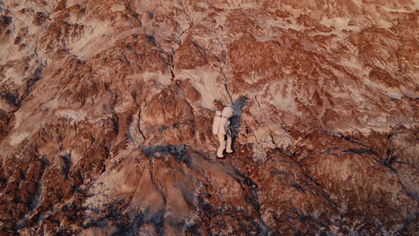 the Astronaut Walks Carefully Along the Rock and Then Stops