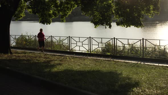 Silhouette of Fat Woman Running in the Park