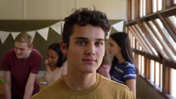 Portrait of teenage boy in school classroom