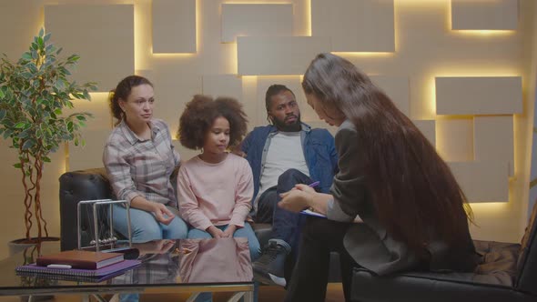 Psychotherapist Working with Multicultural Family and Kid During Therapy Session