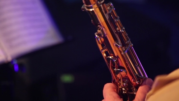 The Man In The White Suit Playing The Saxophone At