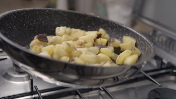 Potatoes and meat cooking slowmotion