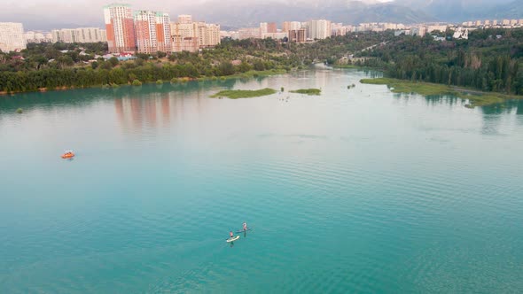 Man Ride on SUP Board in the Mountain Lake