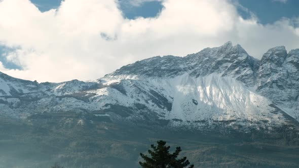 Piltriquitron Mountain peak during sunrise with patchs of sun light panning to right