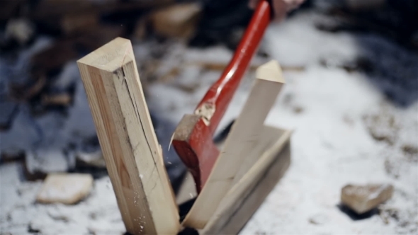 Forester Chopping Wood With An Axe 