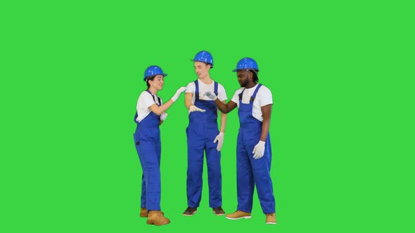 Group of Workers Put Hands on One Another and Rising Their Hands for Motivation on a Green Screen