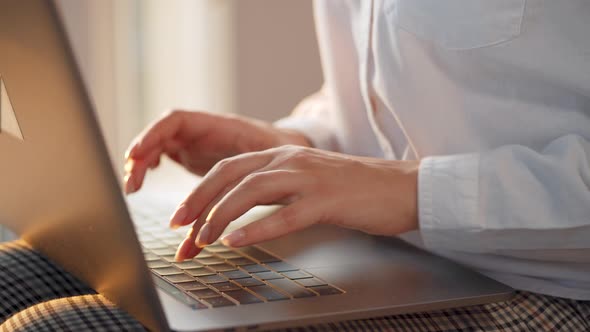 Closeup Woman Working on a Laptop Against the Sunset