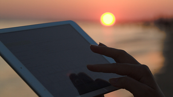 Woman Hands Typing On Pad Outdoor At Sunset