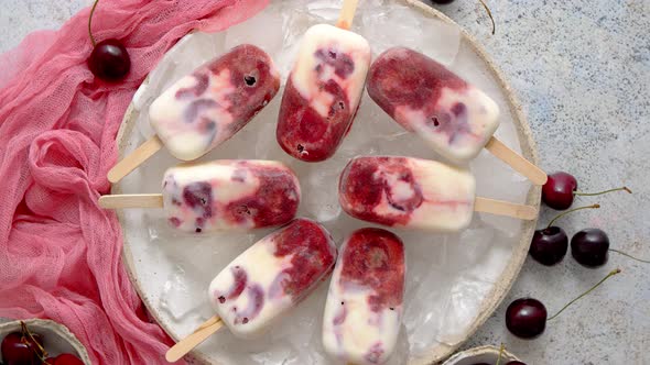 Homemade Vegan Cherry Popsicles with Coconut Milk. Placed on Ceramic Plate