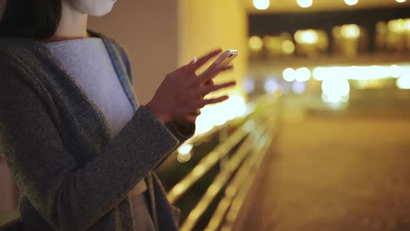 Woman working on mobile phone at night, mobile office concept