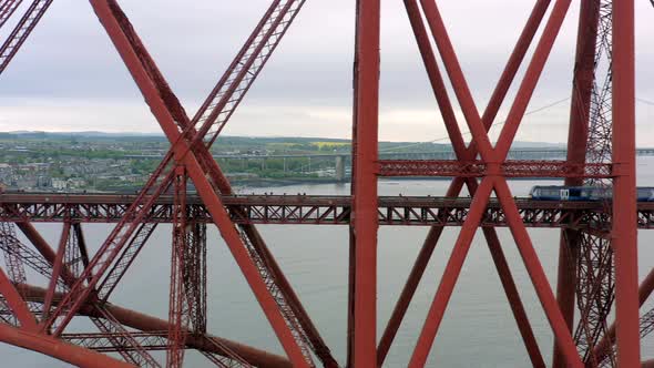 A Train Crossing a Red Bridge in Scotland