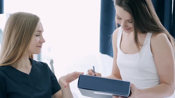 Patient Filling in Questionnaire Before Procedure in Beauty Salon