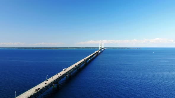 Aerial footage of the Mackinac Bridge and the blue waters of Lake Michigan and Lake Huron