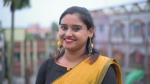 A beautiful Indian married woman smiles and laughs at the camera