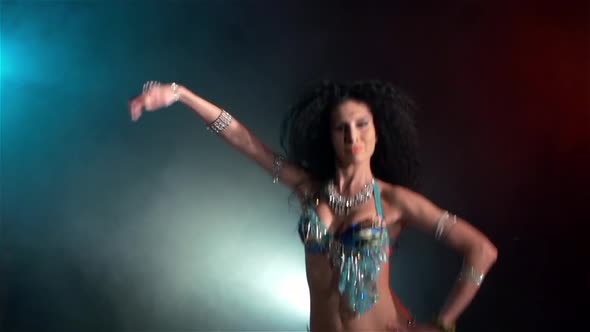 Beautiful Young Belly Dancer Go on Dancing, Slow Motion, in Smoke