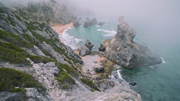  View From Above of Rocks in Morning Fog at Praia Da Ursa Beach in Sintra, Portugal