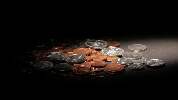 Coins on a Dark Surface. Spot Light