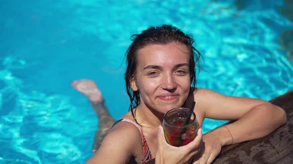 High Angle View of Smiling Satisfied Young Woman Drinking Cocktail Smiling in Slow Motion at