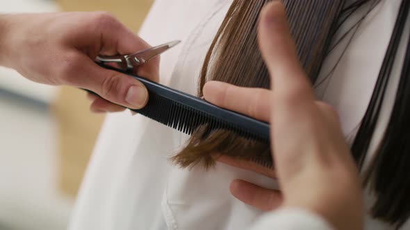Handheld view of woman has cutting hair at the hairdresser. Shot with RED helium camera 