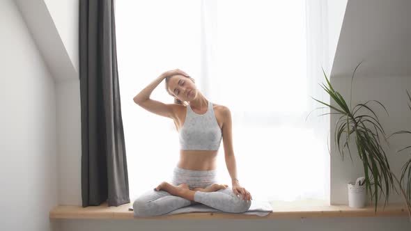 Young Woman Practicing Lotus Pose on Meditation Session, Isolated in Studio