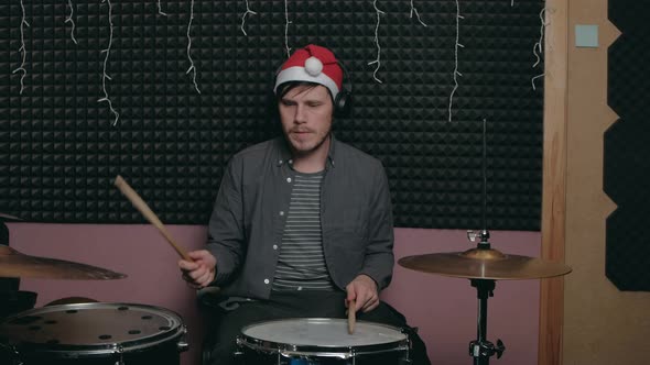 Santa Claus Man Sits Down to Play the Drum Set