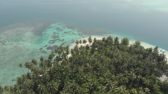 Aerial: flying over tropical island white beach caribbean sea turquoise water