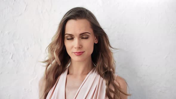 Portrait of Gorgeous Woman with Waving Hair Posing Isolated