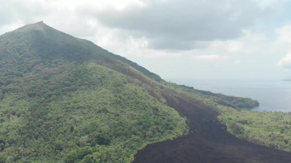 Aerial: flying over Banda Islands active volcano Gunung Api lava flows Indonesia