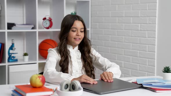Happy Child Starting School Online Lesson with Laptop Wearing Headphones Communication Technology