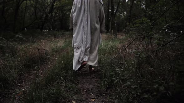 Jesus In White Robe Walks In Woods In Slow Motion