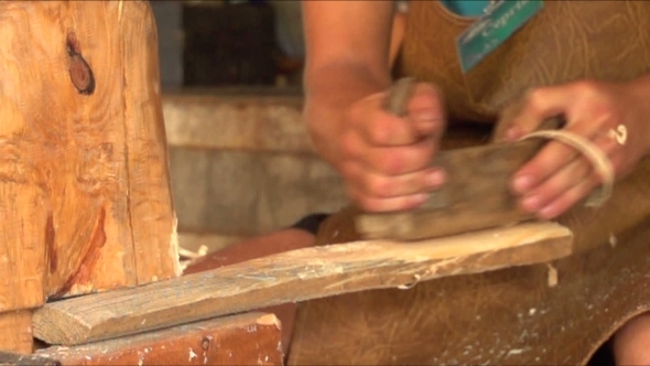 Carpenter Cleans Wood Plane