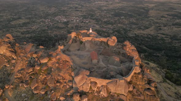 Monsanto castle ruins used for establishing shot of games of thrones on hilltop at sunrise, Portugal