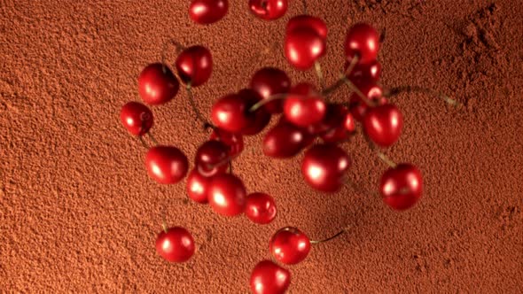 Super Slow Motion Fresh Cherry Falls on the Cocoa Powder