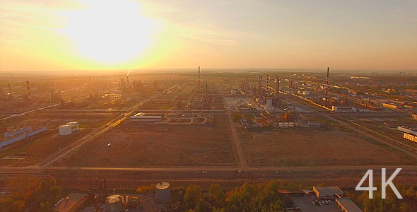 Huge Industrial Plant with Pipes at Sunset