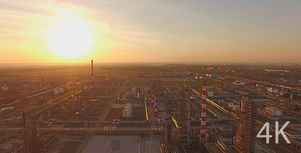 Huge industrial plant with pipes at sunset
