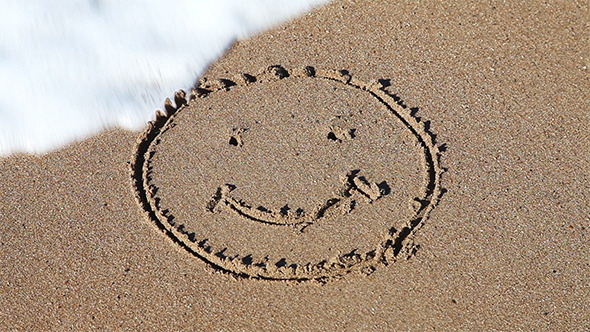 Smiley Face Sign On The Beach Sand