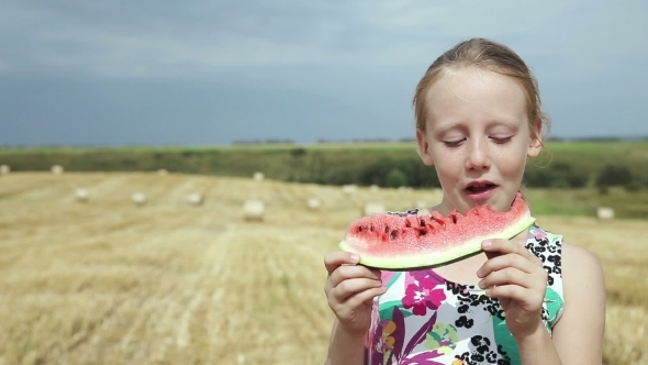 Girl In a Field Eating Watermelon