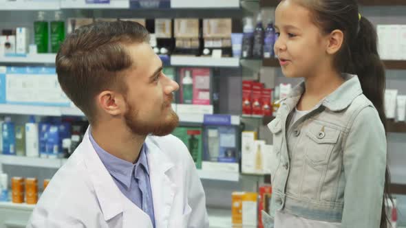 Good Pharmacist Gives a Little Girl Medicine