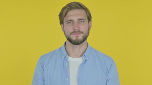 Denying Young Man in Rejection on Yellow Background