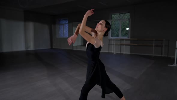 Concentrated Beautiful Woman Dancing in Studio Indoors Rehearsing Performance