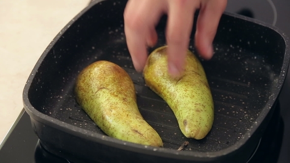 Chef Is Putting Freshly Cut Pear On a Frying Pan