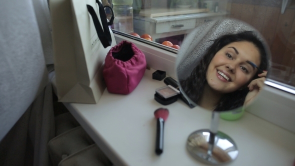 Beautiful Woman Doing Make Up Looking To The