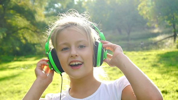 Girl Listens to Music on a Sunny Day