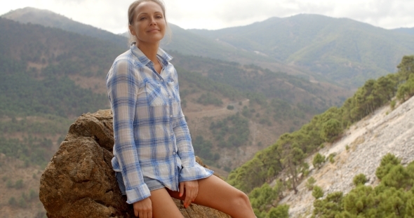 Girl Resting Near Rock In Spanish Mountains