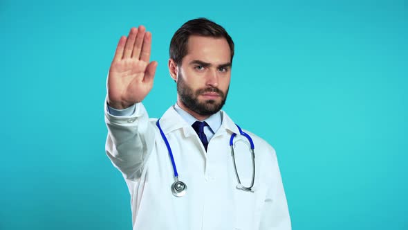 Portrait of Doctor in Medical Coat Showing Rejecting Gesture By Stop Palm Sign