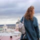 Young Redhaired Woman in a Blue Coat and Walks Against the Backdrop of the Old City - VideoHive Item for Sale