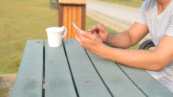 Young Man Using Smartphone, Morning