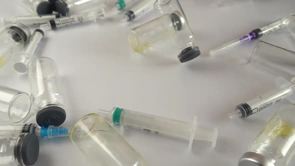 Syringes and falling ampoules. Slow motion.