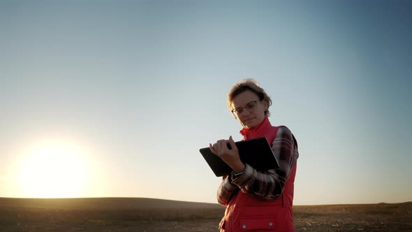 Wide View of Farmer Woman Working with Tablet in Field Analyzes Quality of Crop Before Harvesting